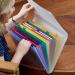 The picture shows an Elba Expanding Files Oxford Expanding File in a vibrant color. It has 13 convenient pockets made of durable polypropylene for organizing documents. The file is secured with a Velcro fastening, ensuring the contents stay in place. Perfect for storing A4 sized papers, this file is a great addition to any office or workspace.