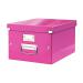 The photo shows a bright pink Leitz click and store collapsible storage box with the brand name and product description on the front. It is medium in size and can hold A4 documents. The box is folded flat and can be easily assembled by clicking the sides together. Sturdy and compact, it is perfect for organizing your office or home space.