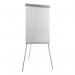 In the photograph, there are two 5 Star flipchart easels with telescopic legs, each holding a whiteboard measuring W670xH990mm. The legs stand at a total height of W700xD82xH1900mm and are accented with a grey trim. The easels are placed side by side, creating a clean and professional display. A stack of extra large flipchart pads can be seen resting on a table next to the easels. The overall appearance is sleek and durable, perfect for any office or presentation setting.