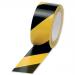 This photo features a roll of 5 Star Quarantine Tape in black and yellow with the words 5 Star Office Hazard Tape printed on it. The tape is made of soft PVC and has an adhesive backing. The dimensions are 50mm by 33m. It is meant for internal use only.