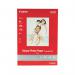 In this photograph, we see a pack of 100 Canon A4 glossy photo paper, weighing 200gsm. The paper appears smooth and shiny, with a pack design featuring the Canon logo and product information. The pack is large and rectangular, with a blue and white color scheme.