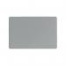The photo shows a grey Durable Desk Mat with a contoured edge measuring 530 x 400mm. The mat is placed on a desk, providing a smooth and protective surface for writing and computer work. The durable material and sleek design make it a practical addition to any workspace.