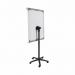This picture features two Bi-Silque Flipchart Easels & Pads, specifically the Bi-Office Classic Mobile Flipchart Easel. The easels are both grey in color and have a magnetic surface measuring 700x1000mm. They are set up for use in a large room with ample natural lighting. The easels are adjustable to the desired height and angle, and have a sturdy, mobile base for easy transportation. They are accompanied by multiple pads of paper, perfect for brainstorming and note-taking. The easels are surrounded by a few chairs and a table, suggesting a collaborative and interactive atmosphere.