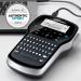 The photo shows a compact handheld label printer with a sleek black and silver design. It features a QWERTY keyboard and is labeled with the Newell Brands and Dymo brand names. The model number S0968960 and 77228NR are visible.