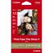 The photo shows a stack of glossy photo paper, specifically Canon PP-201, with dimensions of 10 x 15cm. There are 50 sheets in total, ready to be used for printing high-quality photos. The paper has a smooth, shiny finish, perfect for capturing vibrant colors and sharp details.