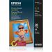 The image shows a pack of Epson A4 glossy photo paper with 20 sheets. The packaging features the Epson logo and product name. The paper has a shiny finish and is meant for printing photos.