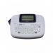 The picture shows a compact handheld labelling machine from Brother, the PT-M95. It features the Brother logo and label makers in bold white text against a sleek black background. The machine has a clear LCD screen and a built-in keyboard for easy use.