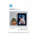 The image shows a pack of 100 glossy photo papers from HP, specifically designed for high-quality photo printing. Each paper is 250gsm and measures 10x15cm, with a borderless design for a professional finish. The pack is neatly arranged in a stack, with the HP logo prominently displayed.